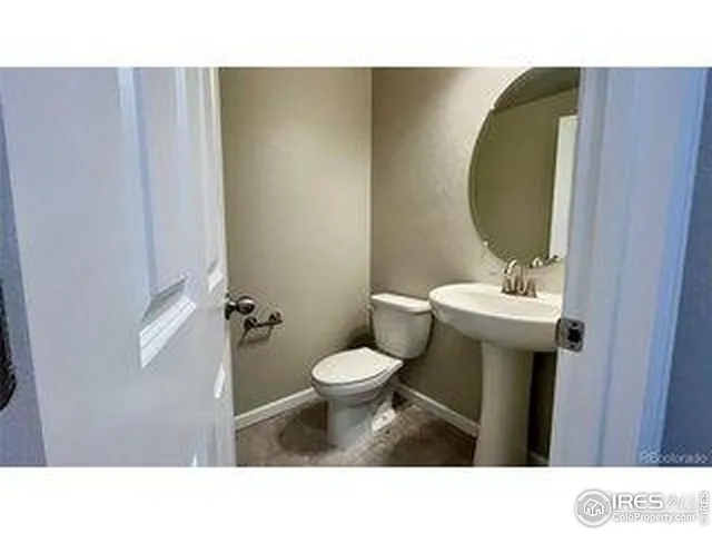 a bathroom with a sink toilet and a mirror
