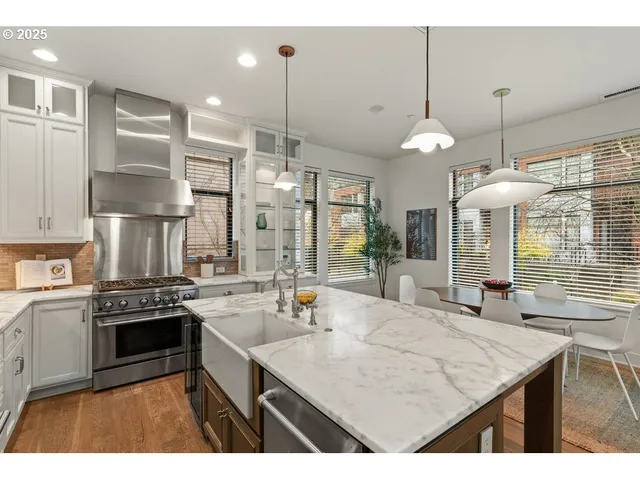 a kitchen with kitchen island a counter space a sink appliances and cabinets