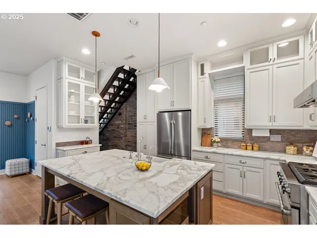 a kitchen with a table a sink and cabinets