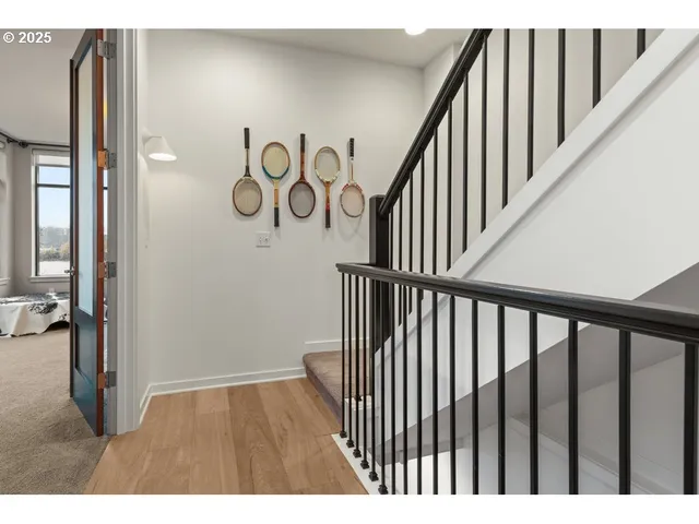 a view of staircase with railing and white walls