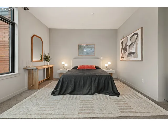 a bedroom with a bed and a night stand