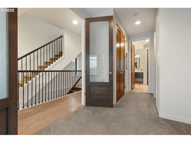 a view of a hallway with wooden floor and entryway