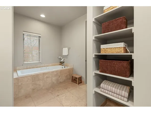 a bathroom with a bathtub and a window