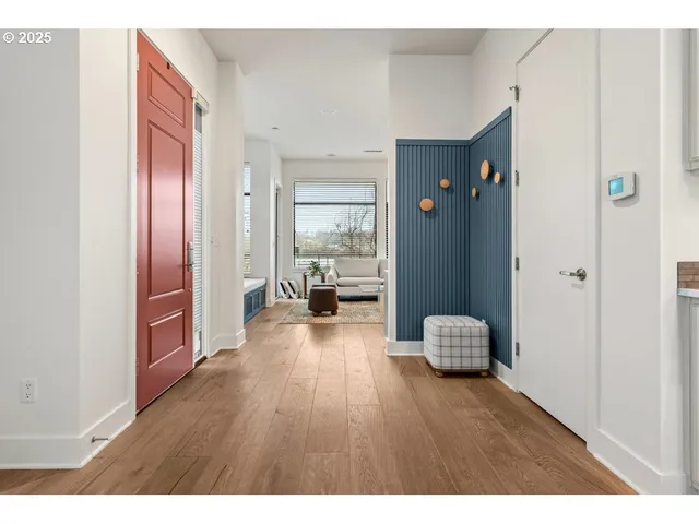 a hall way with furniture and wooden floor