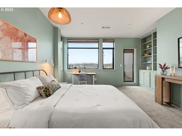 a bedroom with a large bed and a large window