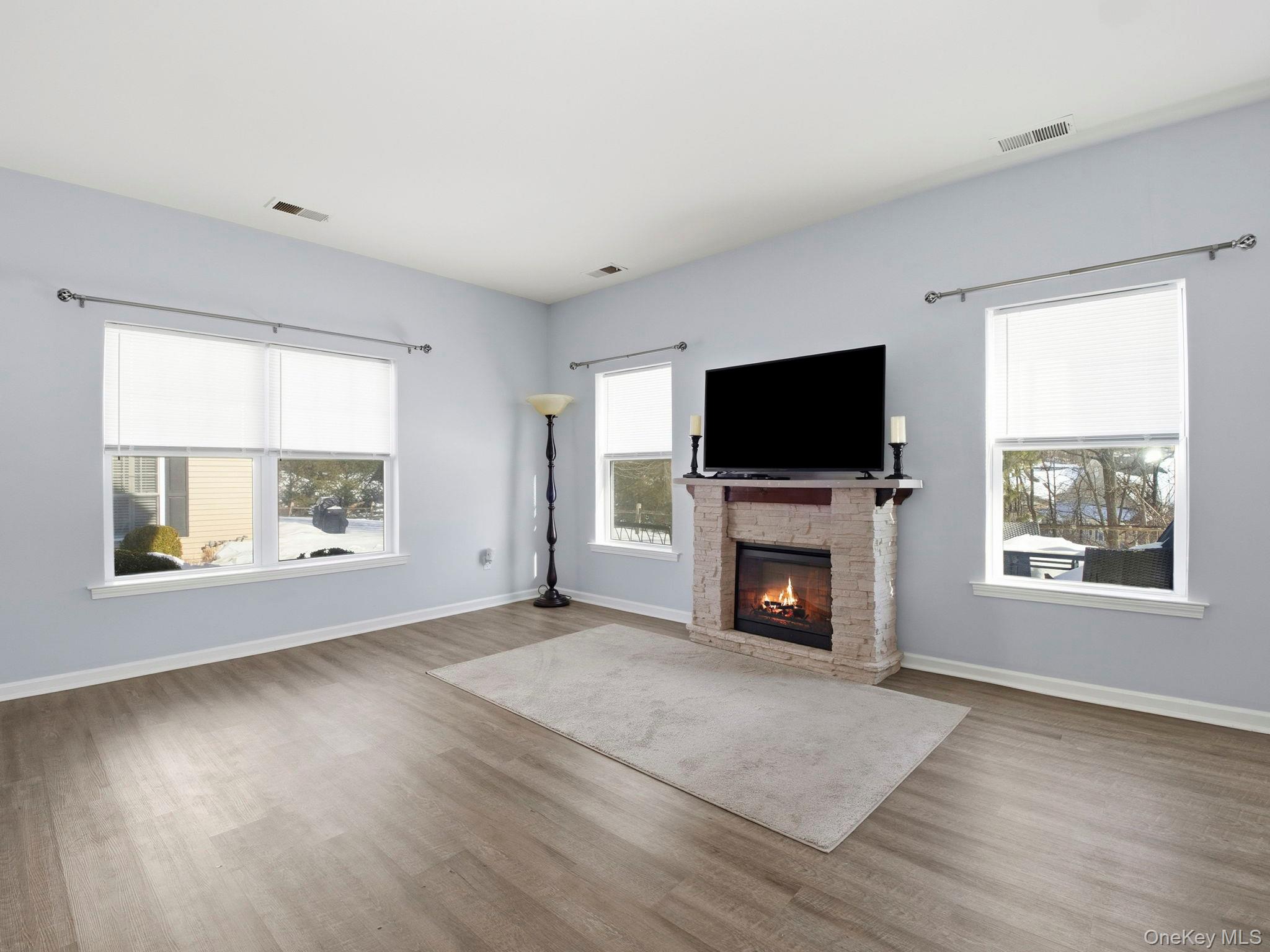 15 Revolution Road Cold Spring, NY 10516 - Photo 8 of 30 an empty room with windows and a fireplace