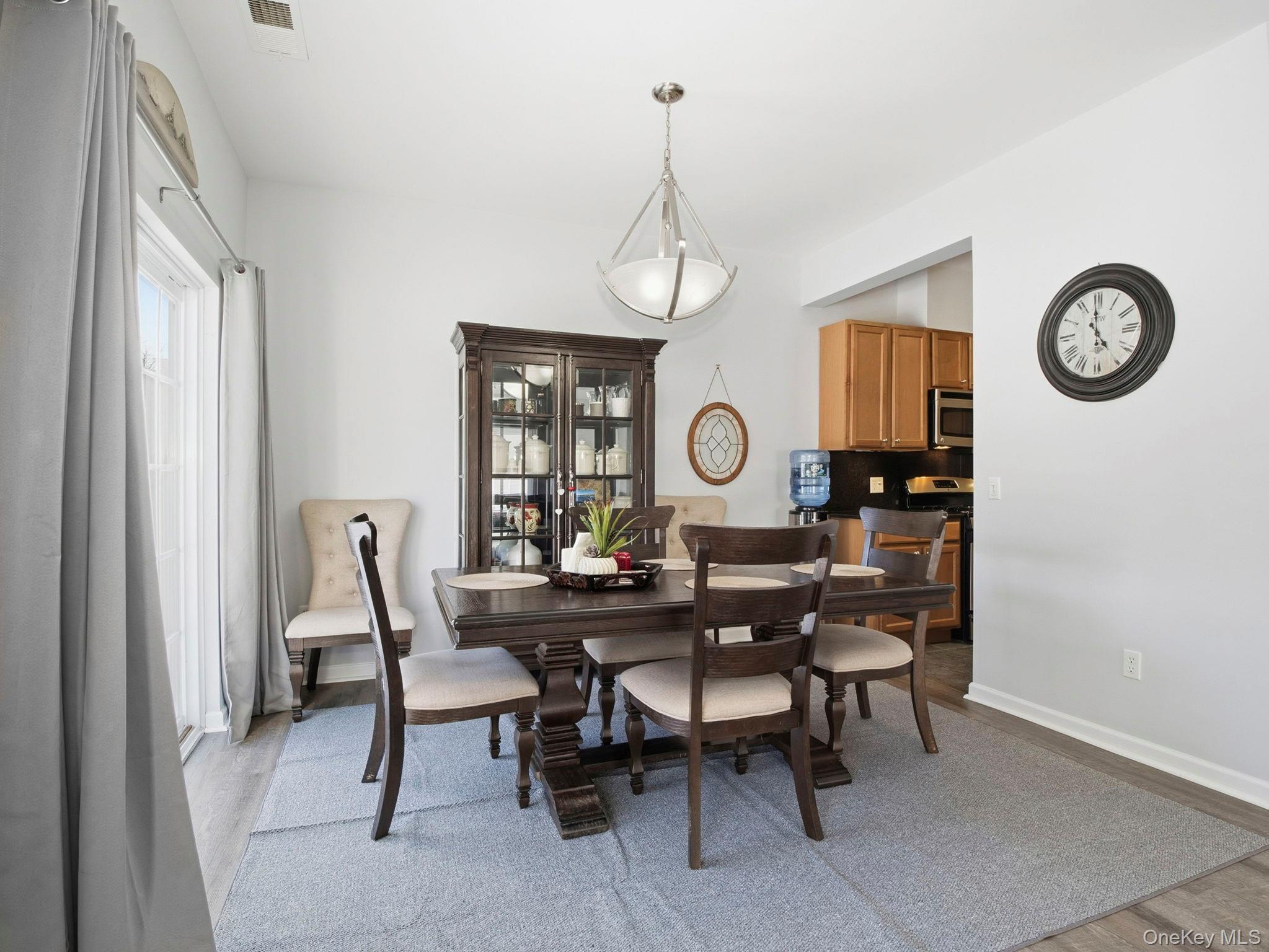 15 Revolution Road Cold Spring, NY 10516 - Photo 10 of 30 a view of a dining room and livingroom with furniture a rug a fireplace and a window