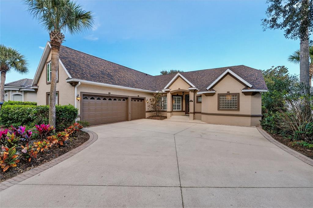 79 Front Street Palm Coast, FL 32137 - Photo 1 of 1 a view of a house with a yard and potted plants