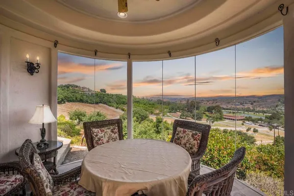 a view of a porch with furniture and a yard
