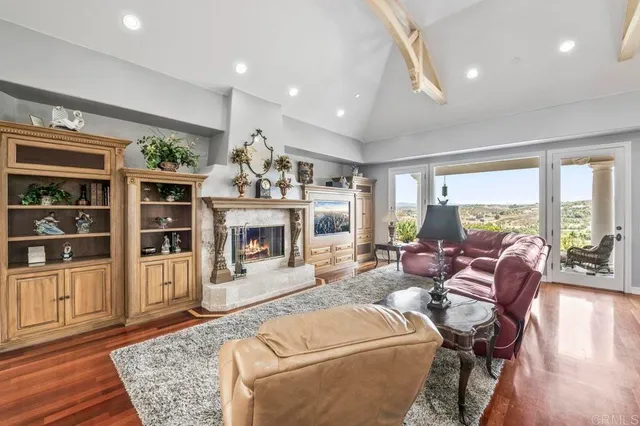 a living room with lots of furniture and a large window