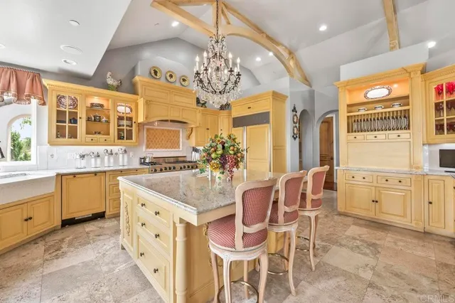 a dining room with furniture a chandelier and wooden floor
