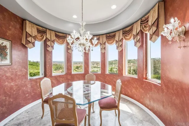 a dining room with furniture a chandelier and window