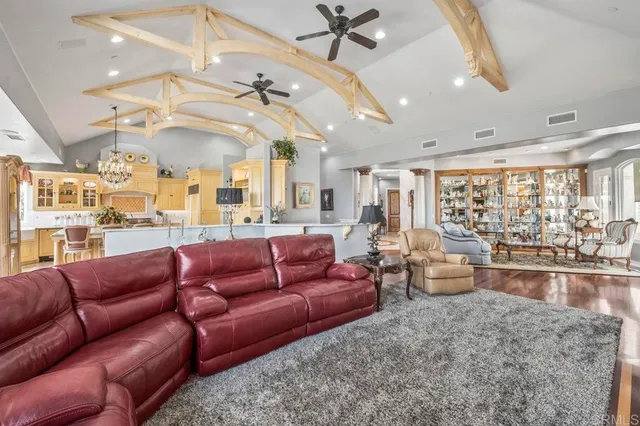 a spacious bedroom with a bed and a chandelier