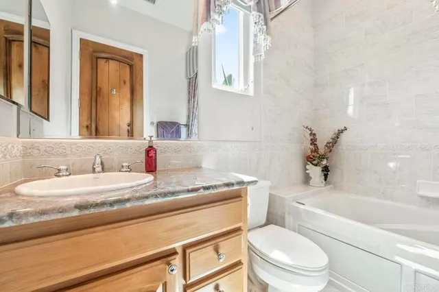 a view of a patio with table and chairs with wooden floor and fence
