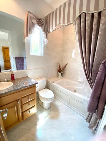 a front view of a house with garden and porch