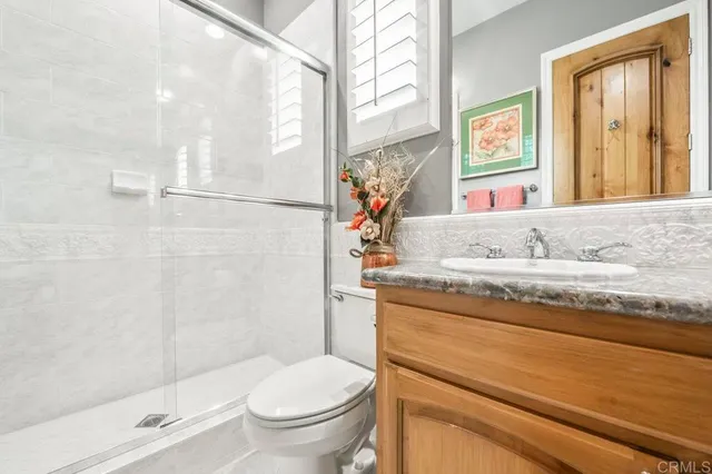 a view of patio with table and chairs under an umbrella