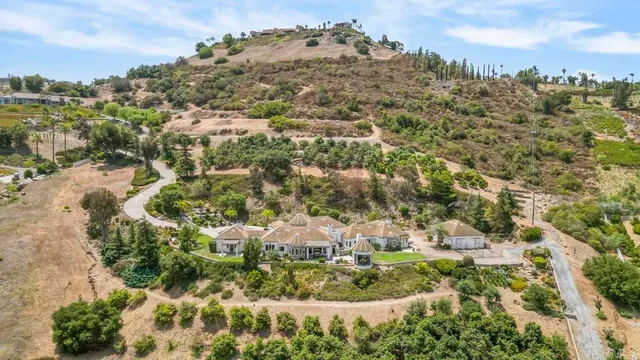 a kitchen with stainless steel appliances granite countertop a stove top oven a sink dishwasher and a dining table with wooden floor