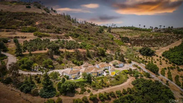 a kitchen with kitchen island granite countertop a sink and white cabinets