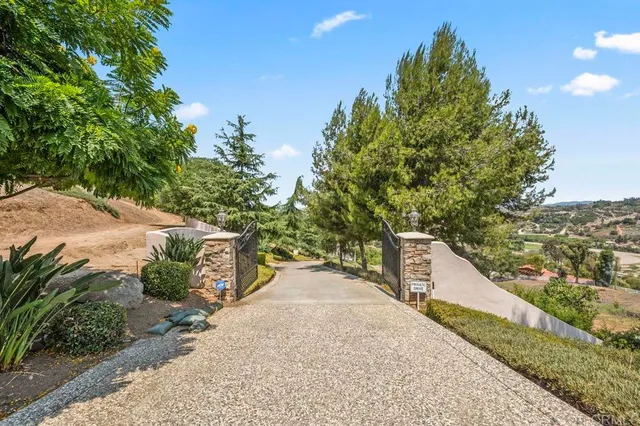 a large white kitchen with granite countertop a sink and a stove
