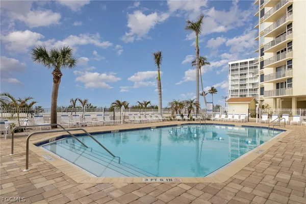 a view of a swimming pool with a lounge chairs