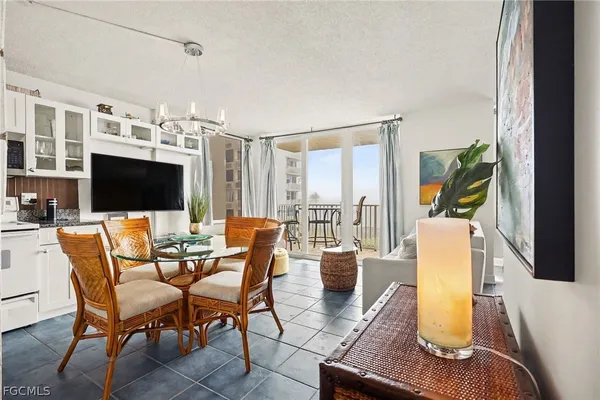a dining room with furniture and a flat screen tv