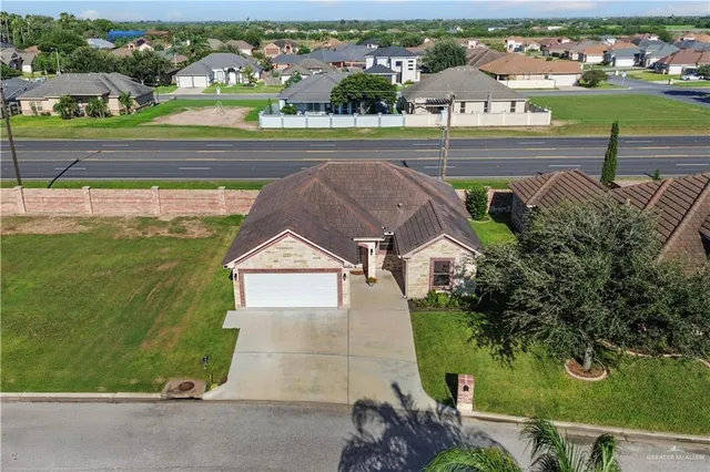an aerial view of a house with a yard