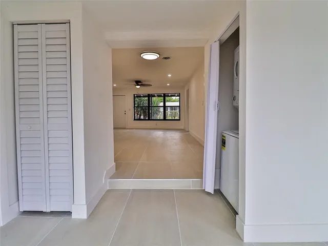 a view of a hallway with wooden shelves