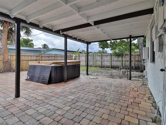 a view of a patio with a table and chairs