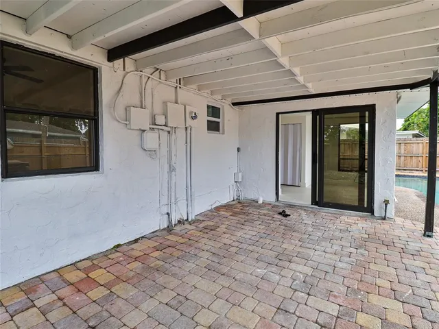 a view of empty room with wooden floor and fireplace