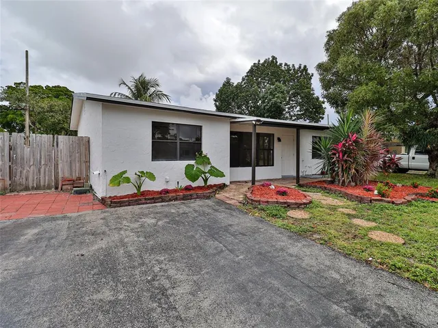 a view of a backyard with a sitting area and potted plants