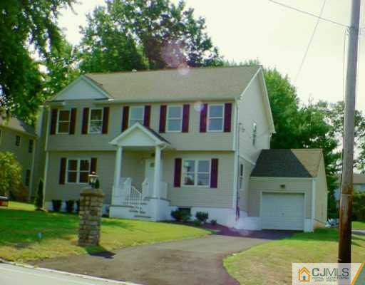 927 Inman Avenue Edison, NJ 08820 - Photo 1 of 2 a front view of a house with a yard