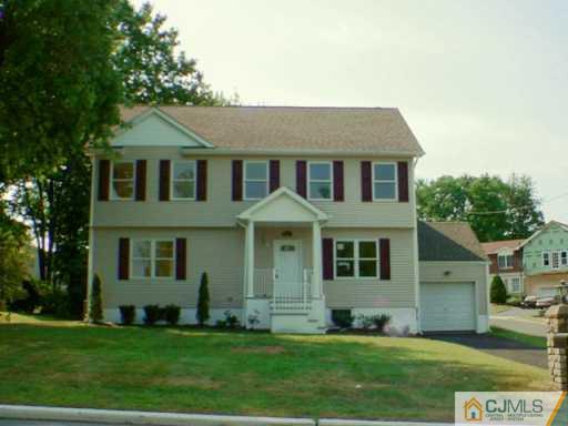927 Inman Avenue Edison, NJ 08820 - Photo 2 of 2 a front view of a house with a yard