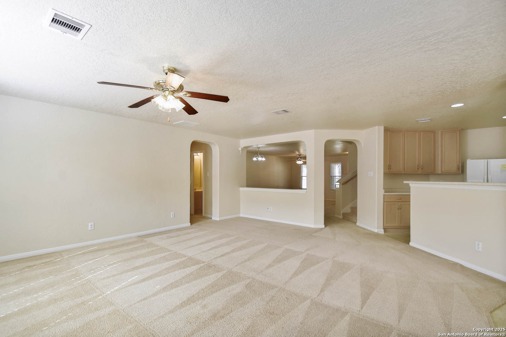 184 Springtree Parkway Cibolo, TX 78108 - Photo 11 of 36 a view of a livingroom with a ceiling fan and kitchen view