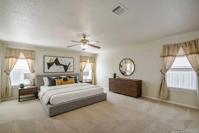 a bedroom with a large bed and a window