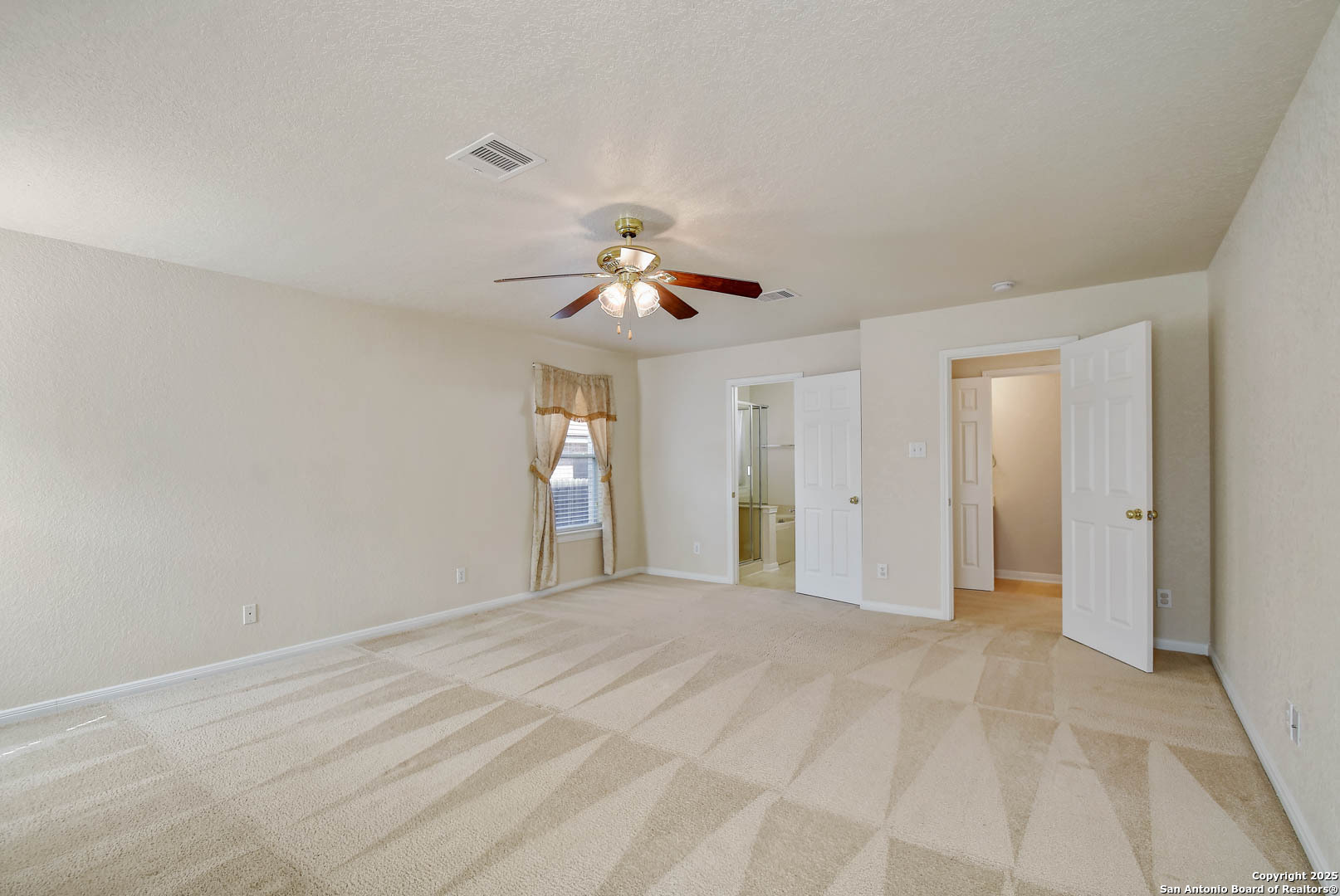 184 Springtree Parkway Cibolo, TX 78108 - Photo 20 of 36 a view of a livingroom with a chandelier fan and windows