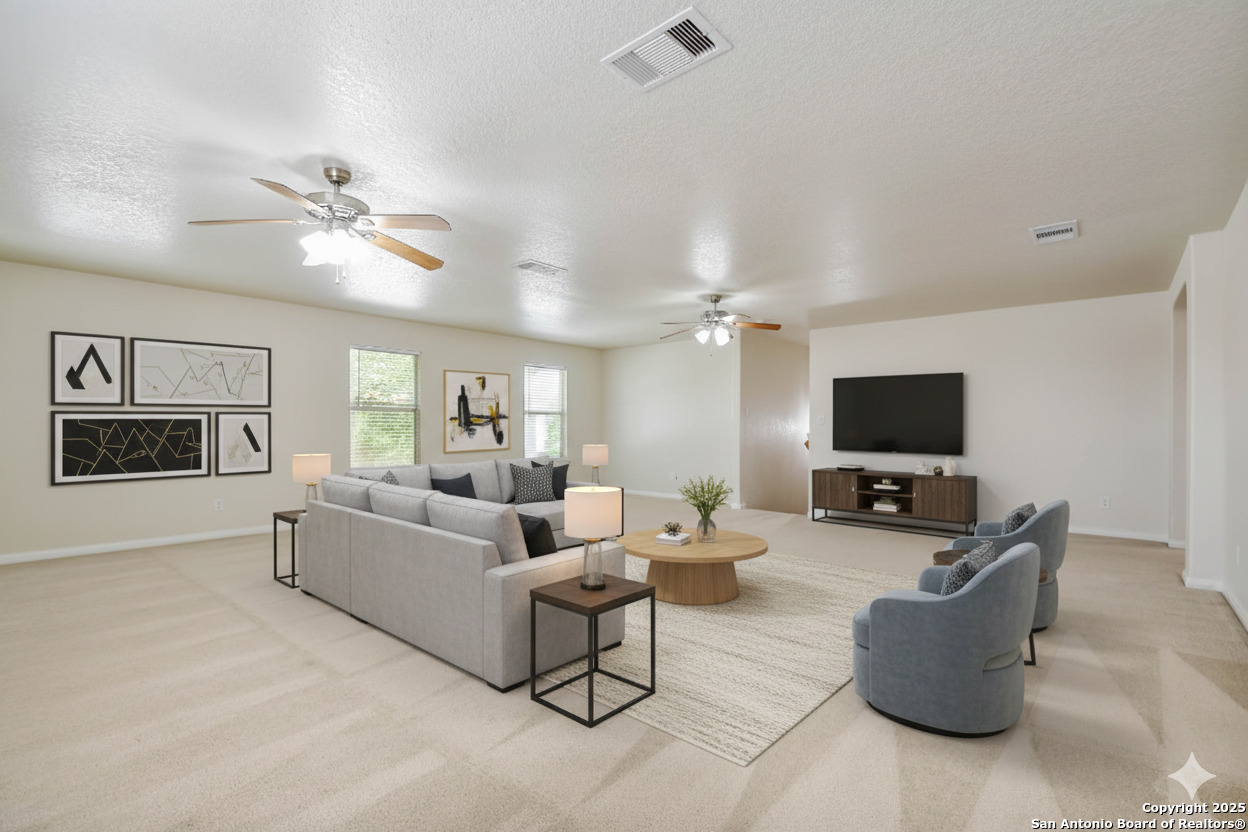 184 Springtree Parkway Cibolo, TX 78108 - Photo 24 of 36 a living room with furniture and a flat screen tv