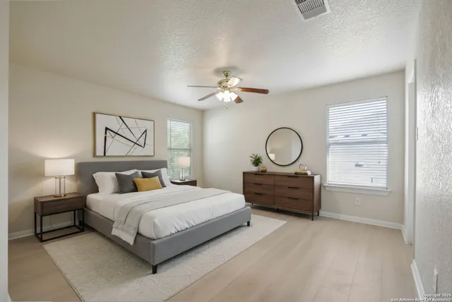a bedroom with a bed mirror and a window