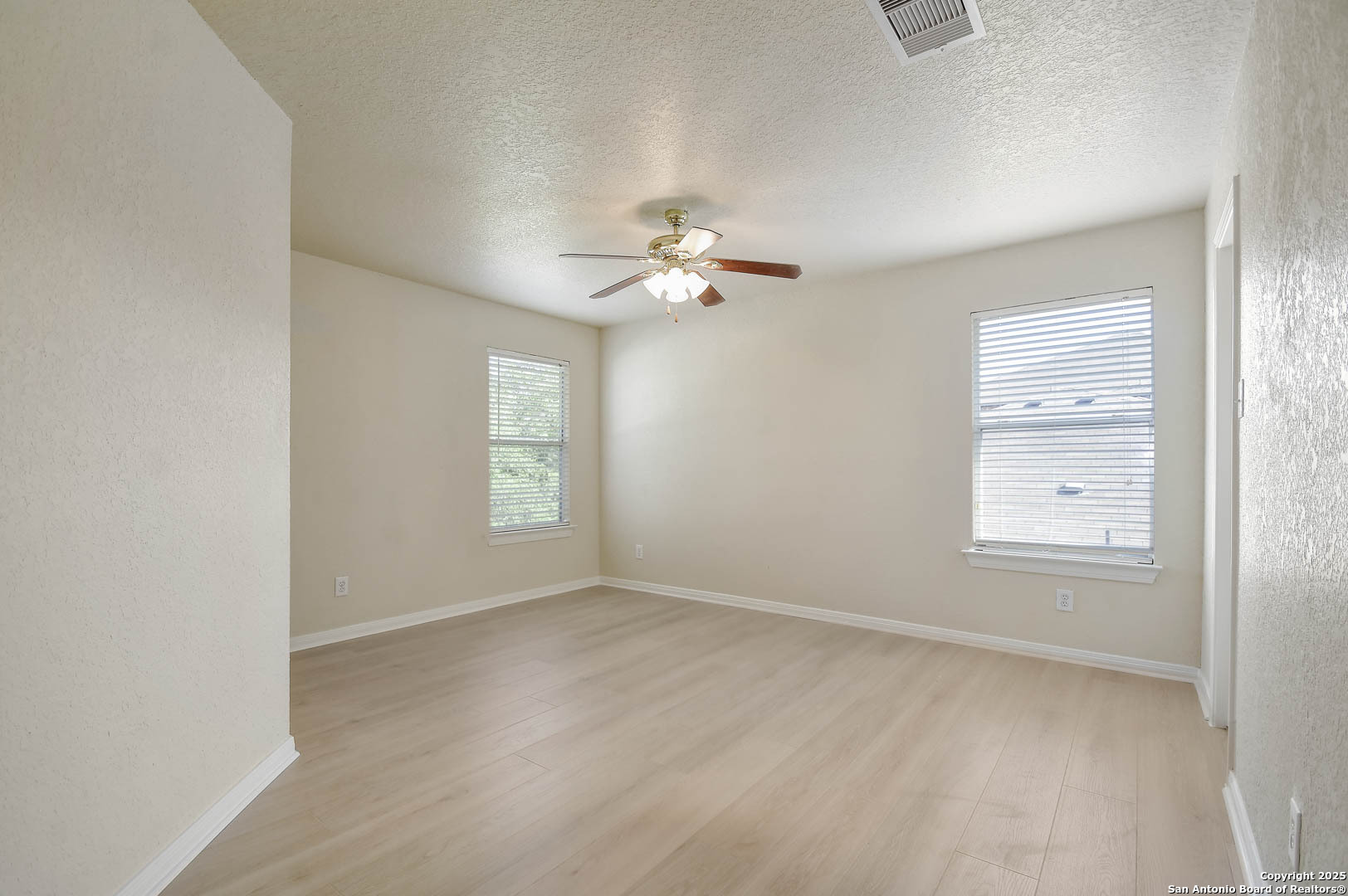 184 Springtree Parkway Cibolo, TX 78108 - Photo 31 of 36 an empty room with a window and a ceiling fan