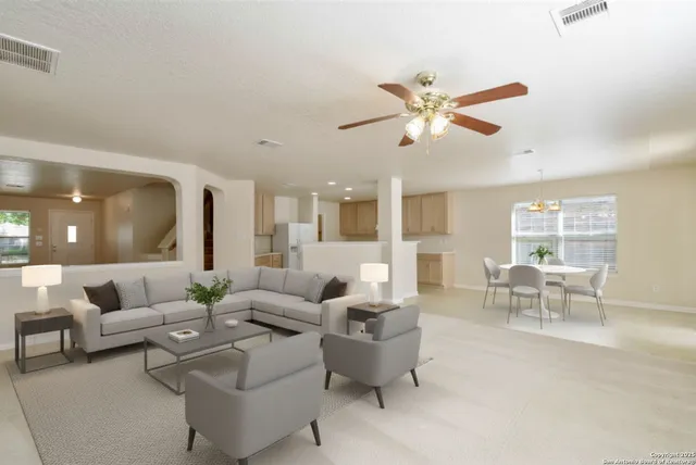 a living room with furniture and a large window