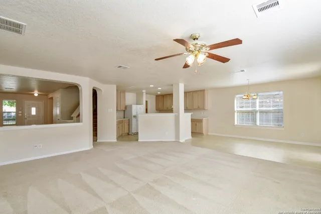 a view of a livingroom with a ceiling fan and window