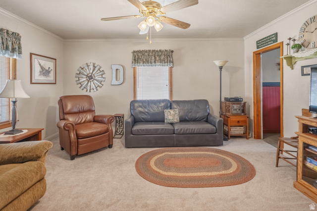 82 South 100 West Lyman, UT 84749 - Photo 25 of 27 Living room with carpet floors, a ceiling fan, and crown molding