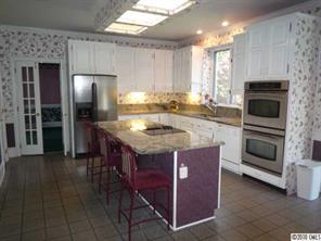 2628 Farmlake Lane Fort Mill, SC 29708 - Photo 6 of 16 a kitchen with kitchen island granite countertop a stove oven and a refrigerator