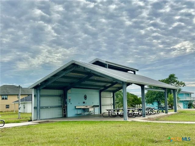 a house view with swimming pool in front of it