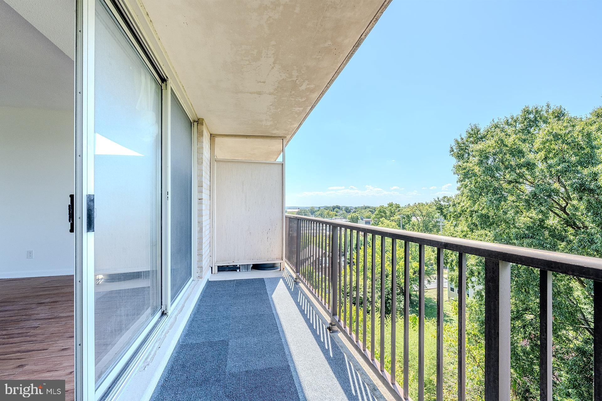 4410 Oglethorpe Street, Unit 713 Hyattsville, MD 20781 - Photo 13 of 24 a view of a balcony with wooden floor and fence