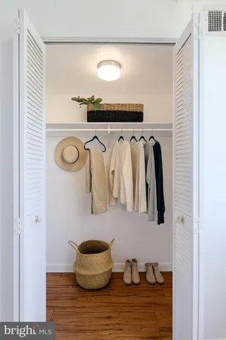 a view of walk in closet with clothes and shoes