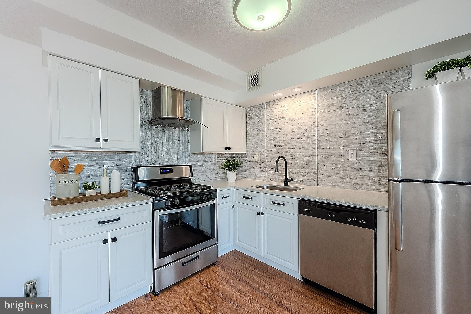4410 Oglethorpe Street, Unit 713 Hyattsville, MD 20781 - Photo 3 of 24 a kitchen with stainless steel appliances granite countertop a stove a sink dishwasher and a refrigerator