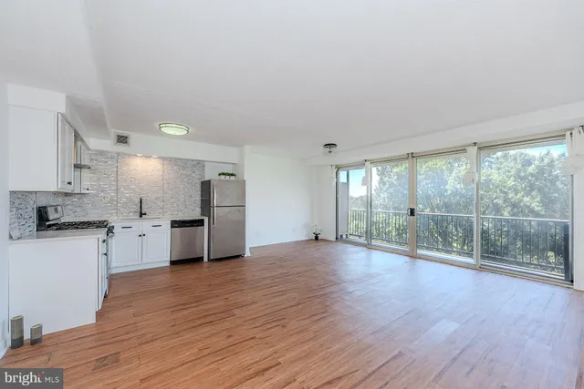 a view of a kitchen with wooden floor and electronic appliances