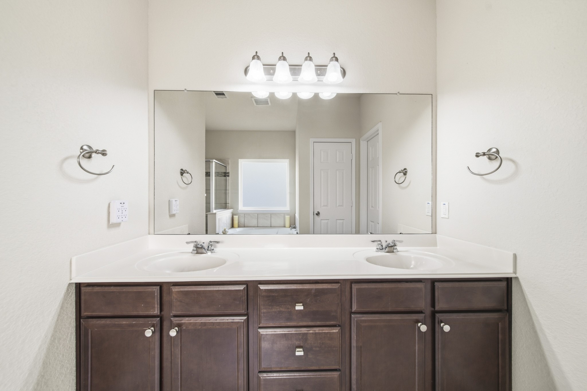 3010 Coachmaker Trail Rosenberg, TX 77471 - Photo 10 of 26 This master bathroom features dual sinks, a large mirror, and wooden cabinetry for everyday convenience.