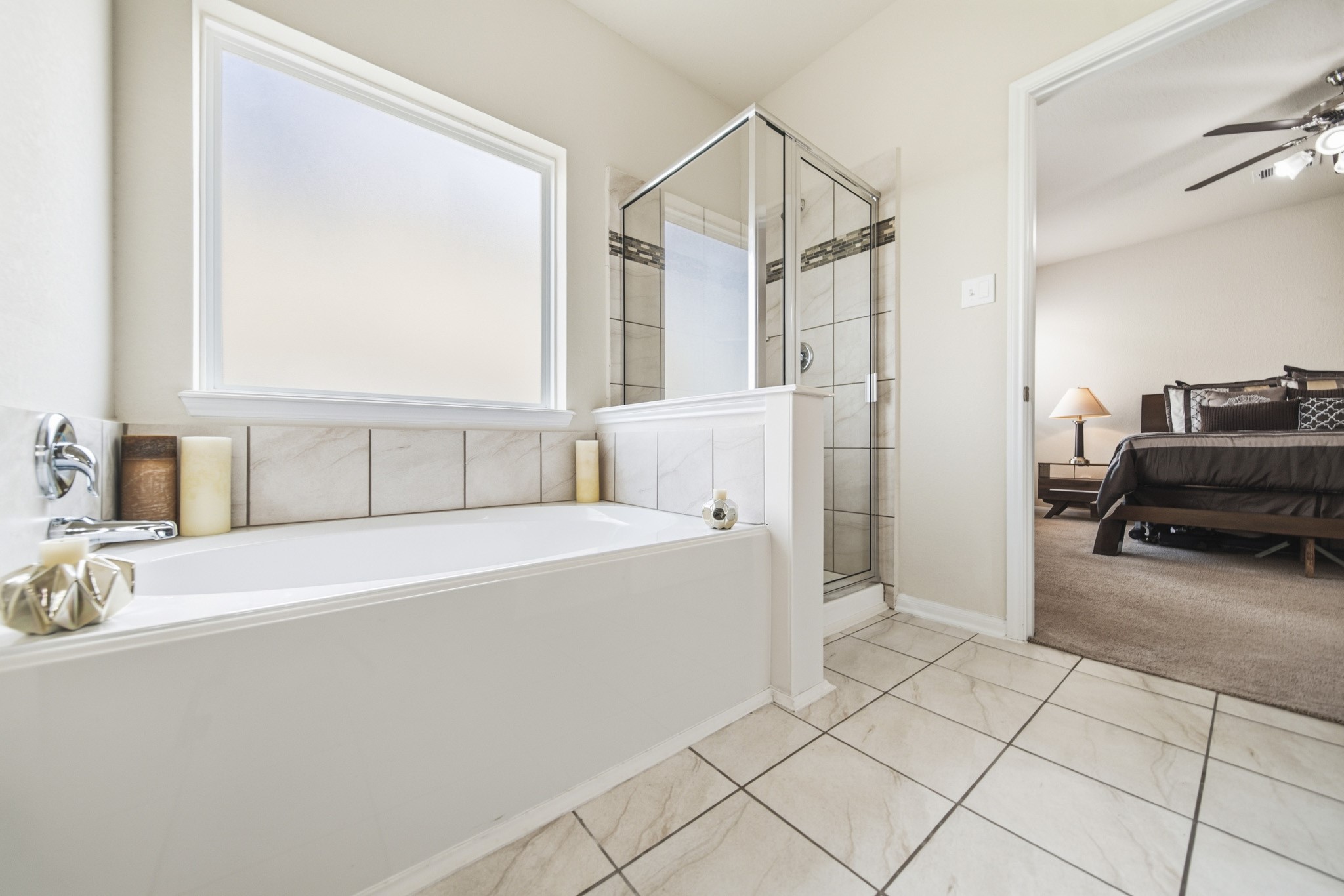 3010 Coachmaker Trail Rosenberg, TX 77471 - Photo 11 of 26 This master bath is complete with a large tub, frozen glass window, and beautiful frameless glass shower with tile surround.