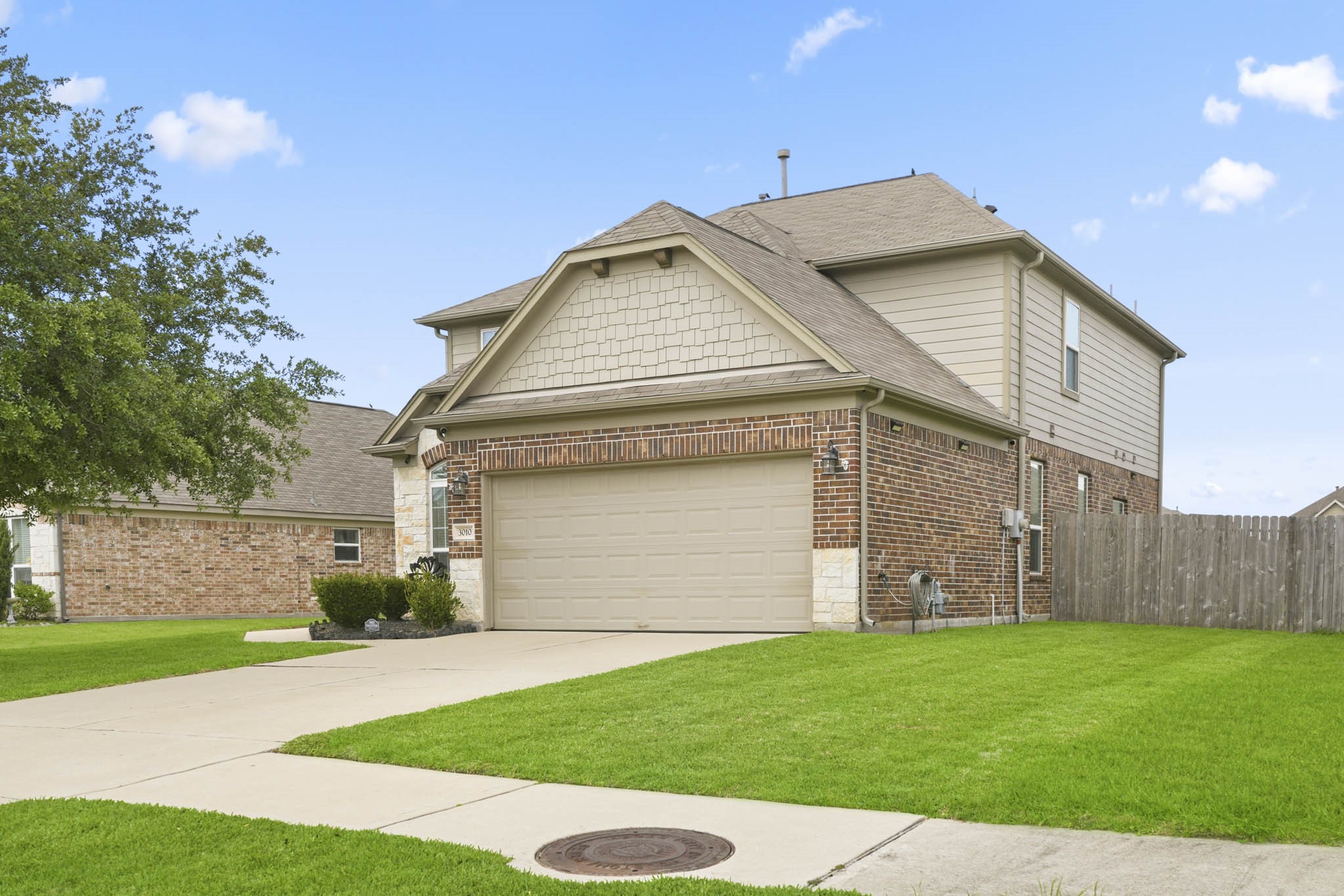 3010 Coachmaker Trail Rosenberg, TX 77471 - Photo 2 of 26 The home features a clean, well-maintained exterior with a spacious two-car garage and an extended concrete driveway, offering ample parking and easy access.
